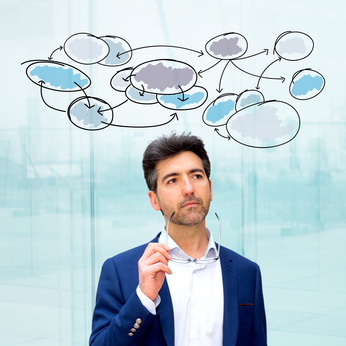 Portrait of an attractive dubious business man with business organigram surrounding his head - Business concept photo : Portrait of an attractive dubious business man with business organigram surrounding his head - Business concept