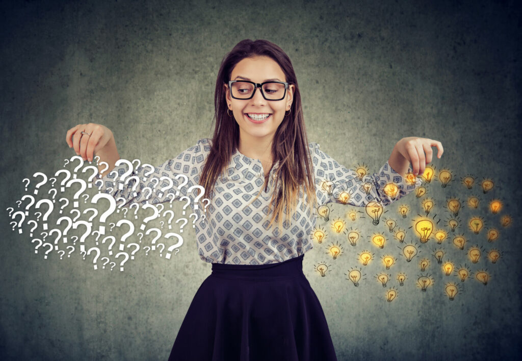 photo : Happy young woman with many questions and answers ideas light bulbs