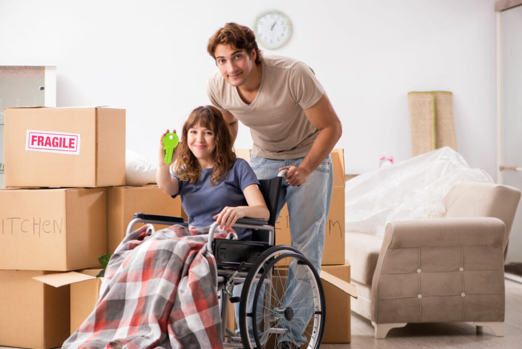 photo : Husband with disabled wife moving to new flat