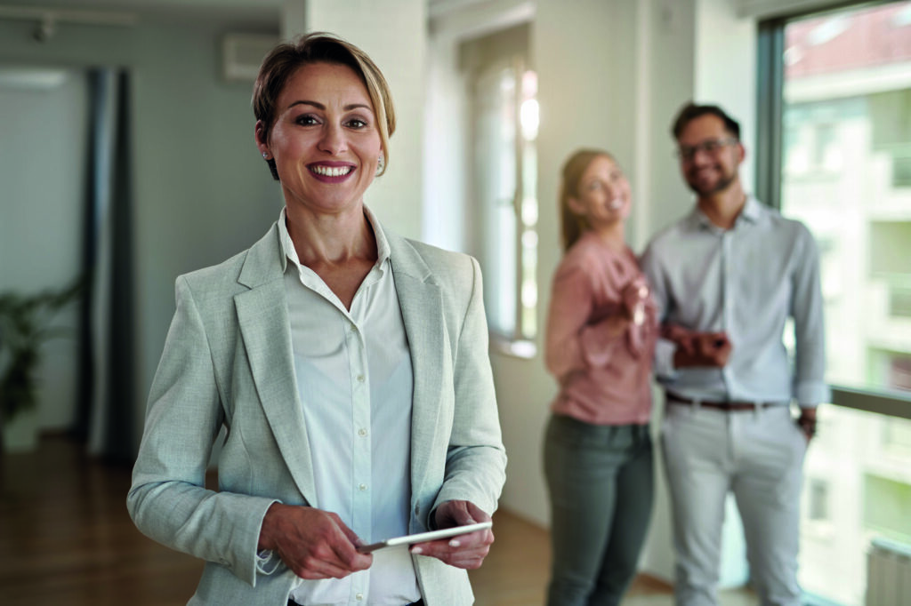 photo : Portrait of happy female real estate agent.