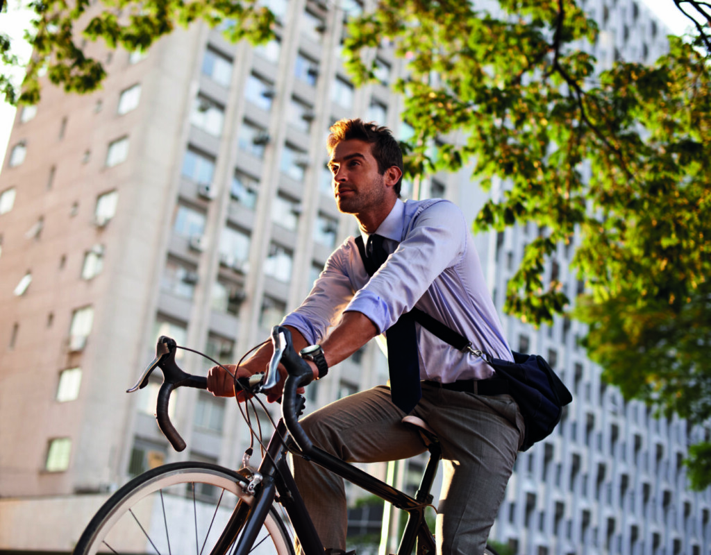 photo : Off to work on his wheels. Shot of a businessman commuting to work with his bicycle.